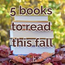 5 books to read this fall in burgundy text over image of a stack of books on fall leaves with green trees in background