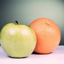 a photo of a green apple beside an orange
