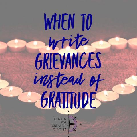 when to write grievances instead of gratitude blue text over lightened image of tea light candles arranged in the shape of a heart on red shag carpet via Unsplash