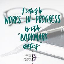 finish works-in-progress with bookmark notes teal text over lightened image of a black journal with a silver ribbon bookmark under black pen beside black rimmed glasses