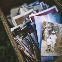 December 2022 photo writing prompt_wooden box of old family photos via Canva