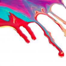 red teal purple and yellow paint spilling and running together to make a pretty mix