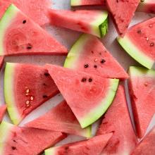 a pile of triangle cut watermelon slices via Canva